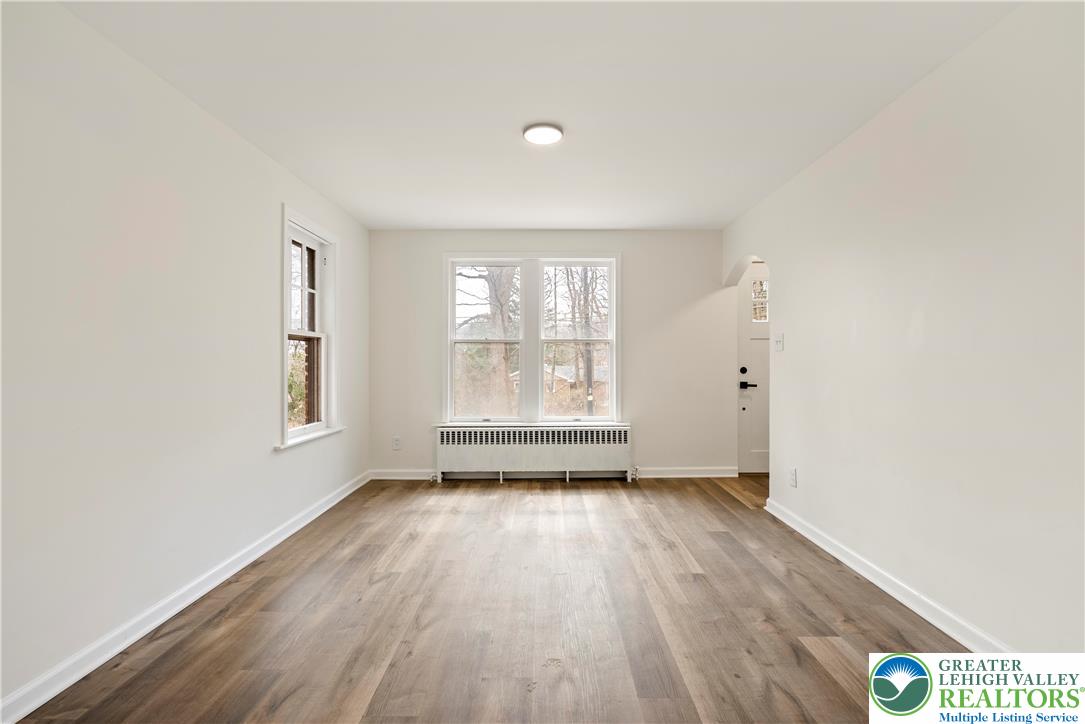 767 East Rock Road Allentown, PA 18103 - Photo 4 of 22 an empty room with wooden floor and windows