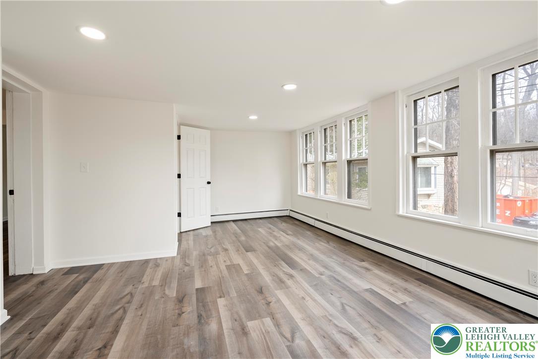 767 East Rock Road Allentown, PA 18103 - Photo 8 of 22 a view of an empty room with wooden floor and a window