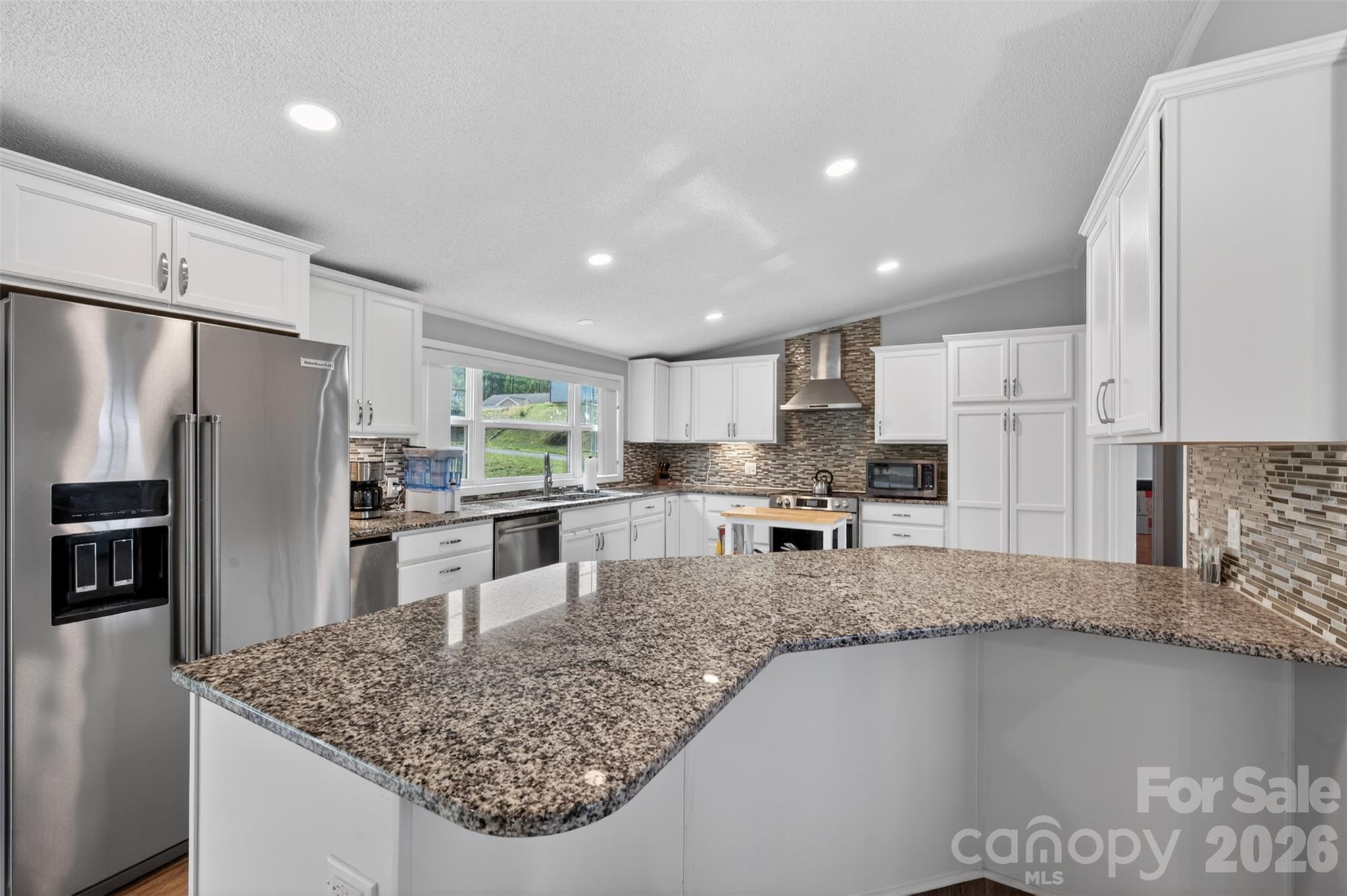 4352 Anderson Mountain Road Maiden, NC 28650 - Photo 13 of 42 a kitchen with stainless steel appliances granite countertop a refrigerator sink and stove
