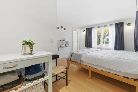 a bedroom with a bed and a table in it