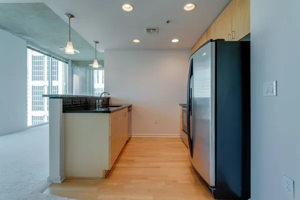 a kitchen with stainless steel appliances a refrigerator and a stove top oven