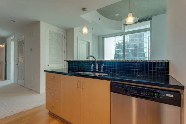 a kitchen with granite countertop cabinets and steel stainless steel appliances
