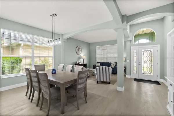 a living room with furniture flat screen tv and a large window