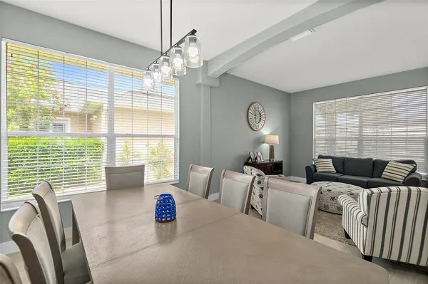a bedroom with a bed wooden floor and a large window