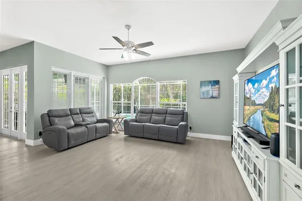 an aerial view of residential houses with outdoor space and trees