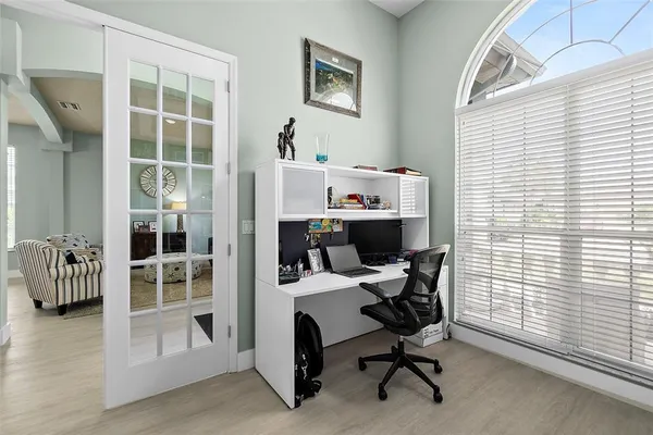 a large kitchen with kitchen island a large counter top appliances and cabinets