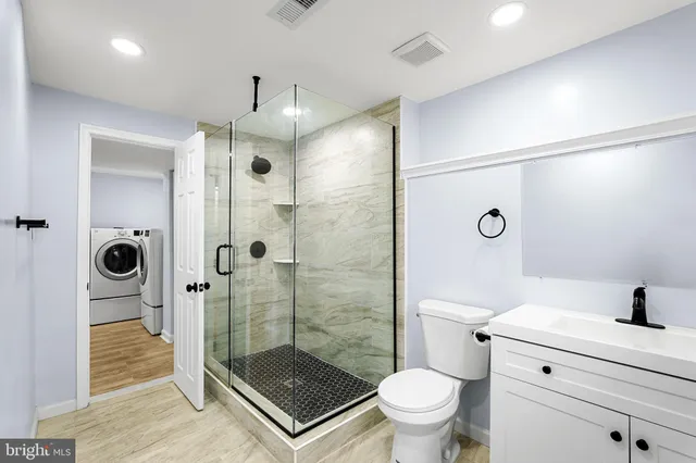 a bathroom with a shower toilet and sink