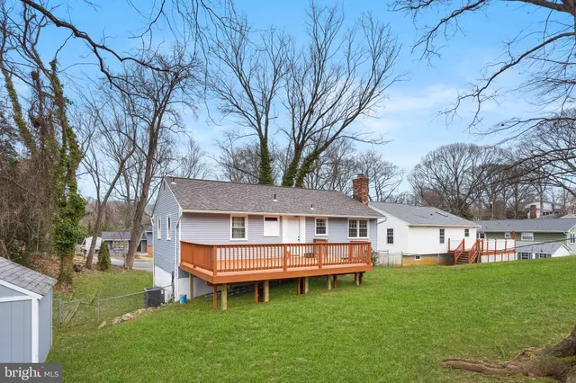 a backyard of a house with yard table and chairs