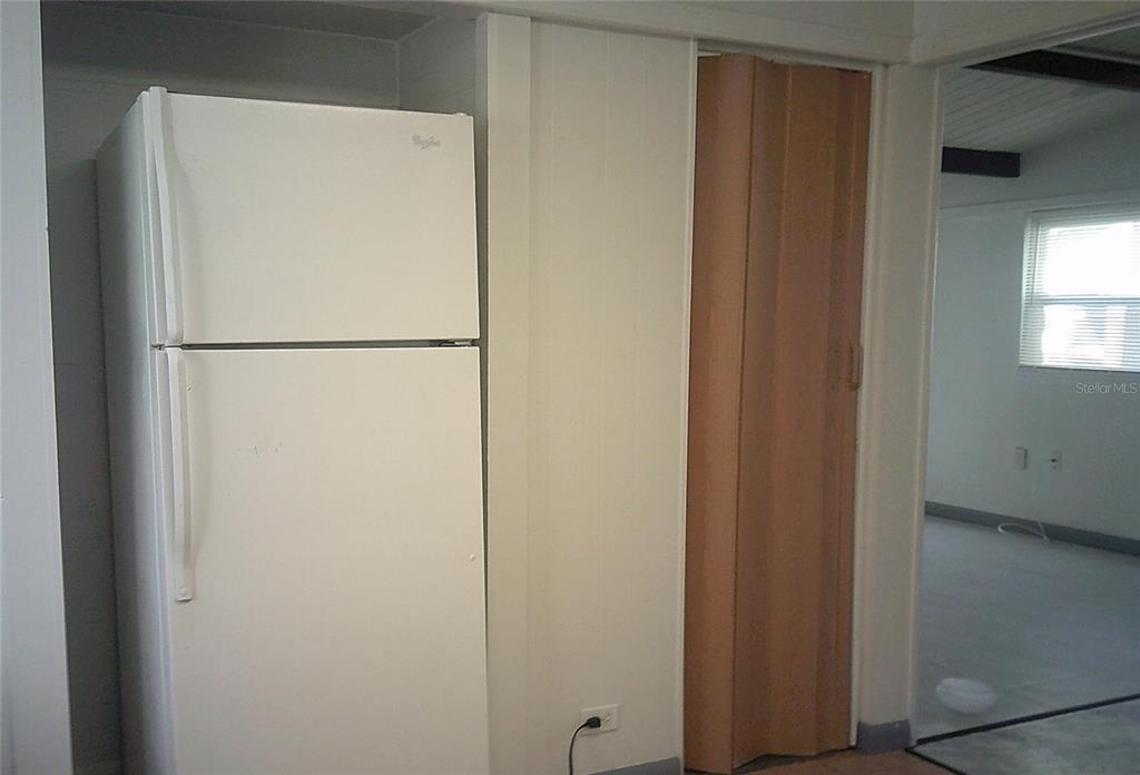 1060 65th Street South St. Petersburg, FL 33707 - Photo 7 of 20 a white refrigerator freezer sitting next to a window
