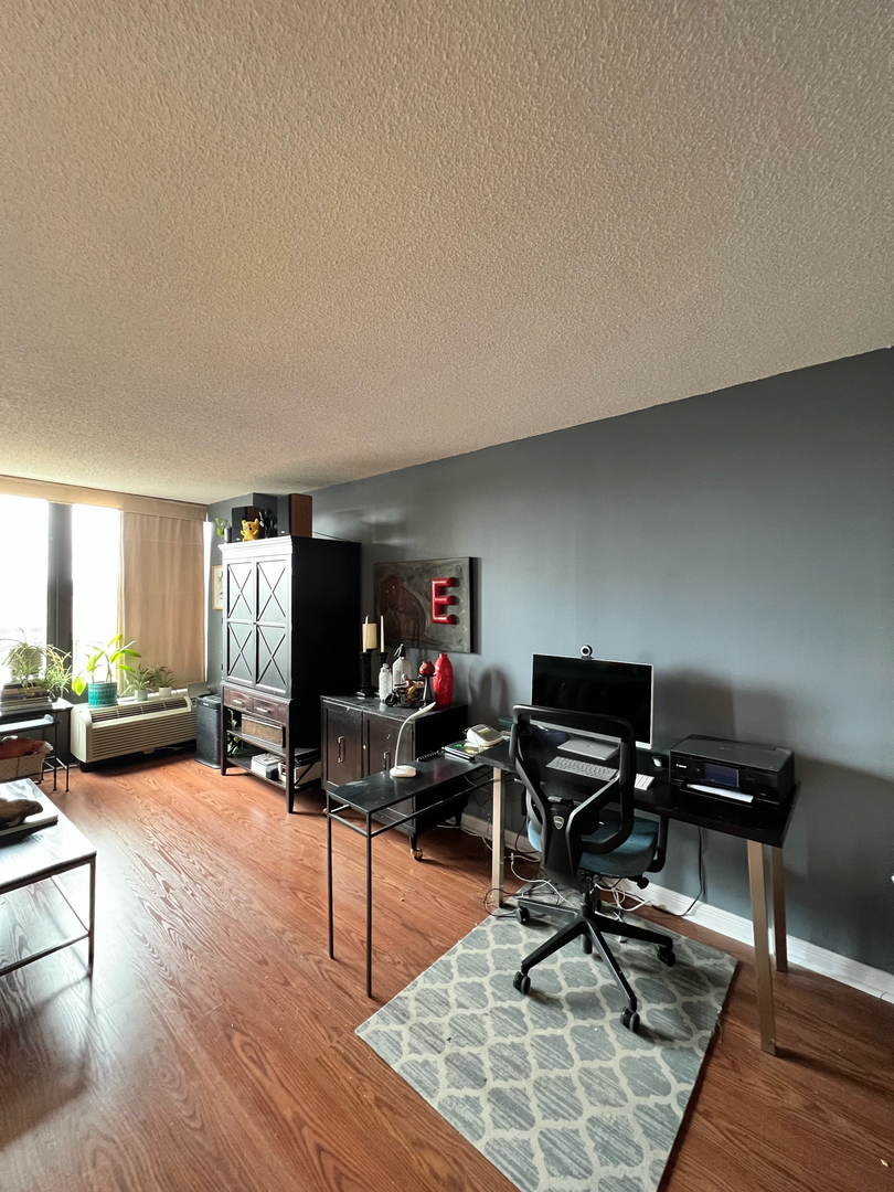 5320 North Sheridan Road, Unit 401 Chicago, IL 60640 - Photo 4 of 17 a workspace with furniture hardwood and a window