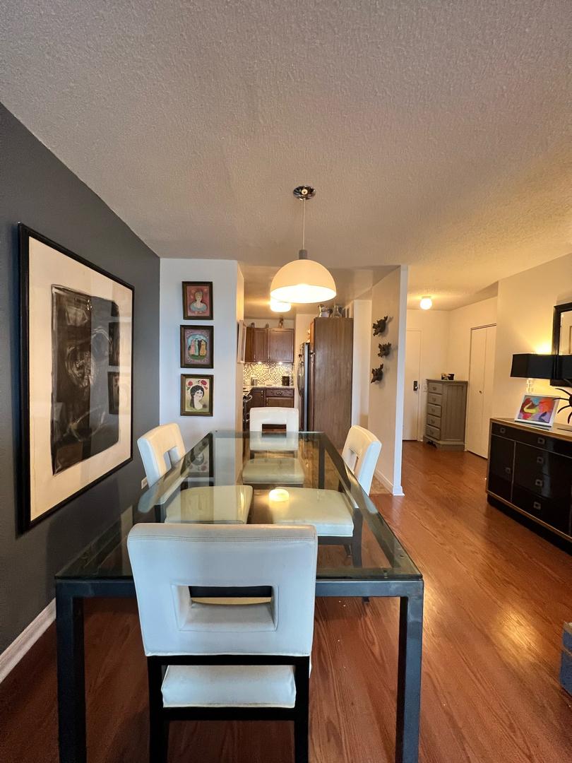 5320 North Sheridan Road, Unit 401 Chicago, IL 60640 - Photo 5 of 17 a dining room with furniture and window