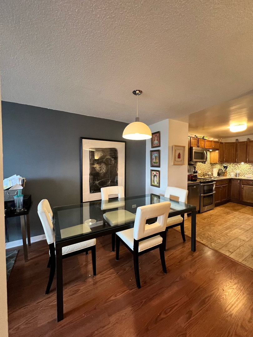 5320 North Sheridan Road, Unit 401 Chicago, IL 60640 - Photo 6 of 17 a living room with furniture and wooden floor