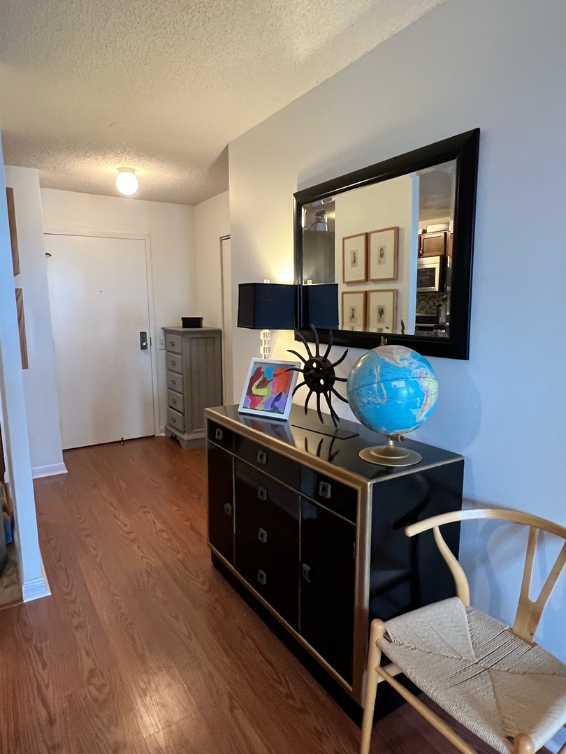 5320 North Sheridan Road, Unit 401 Chicago, IL 60640 - Photo 8 of 17 a living room with furniture and flat screen tv