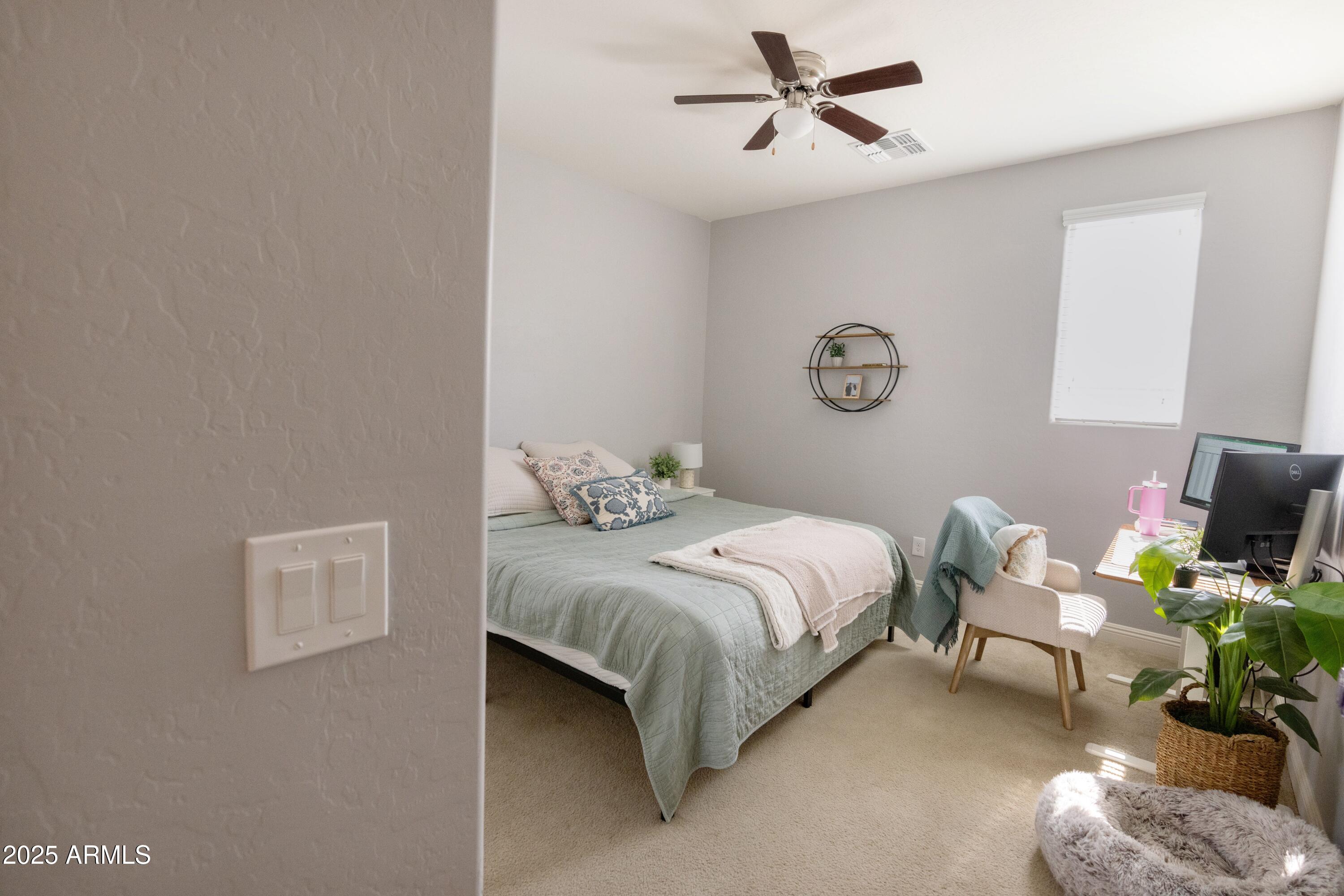 20753 West Legend Trail Buckeye, AZ 85396 - Photo 11 of 21 a bedroom with a bed window and couch