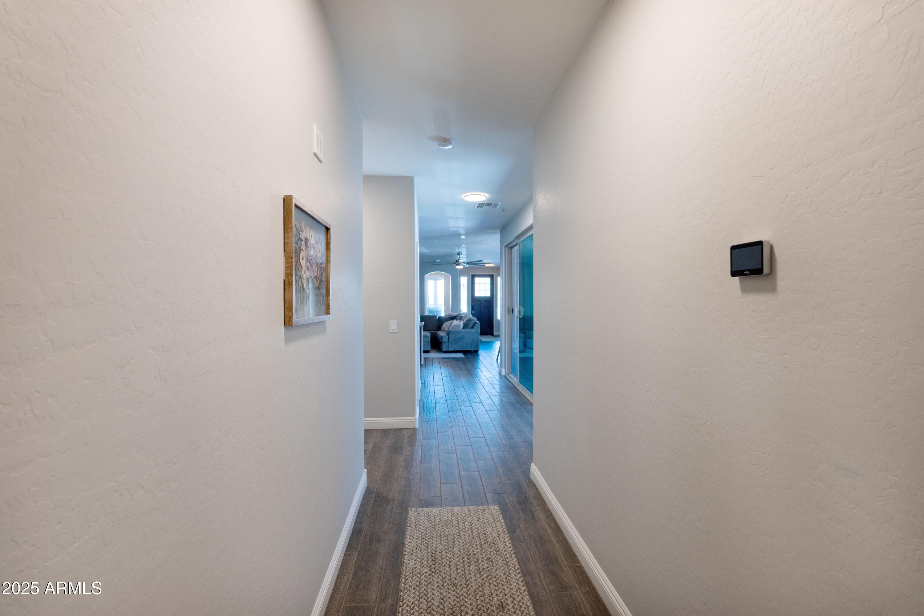 20753 West Legend Trail Buckeye, AZ 85396 - Photo 12 of 21 a view of a hallway with wooden floor