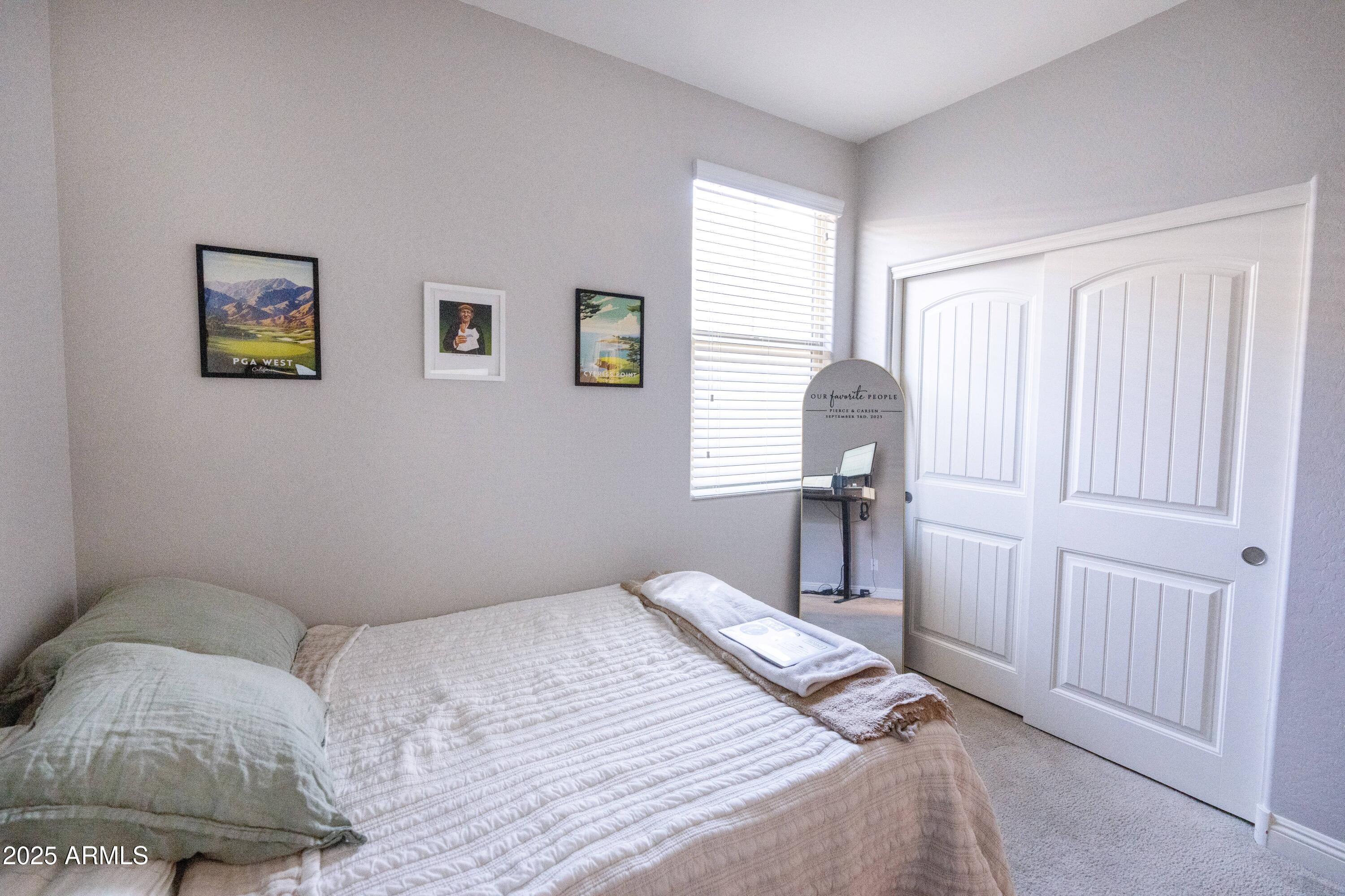 20753 West Legend Trail Buckeye, AZ 85396 - Photo 13 of 21 a bedroom with a bed and a window