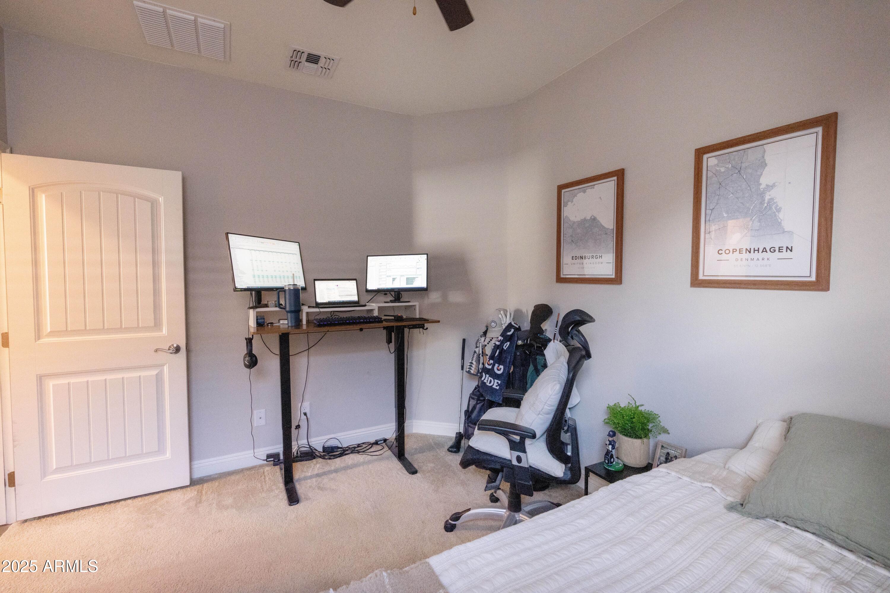 20753 West Legend Trail Buckeye, AZ 85396 - Photo 14 of 21 a bedroom with bed and a painting on the wall