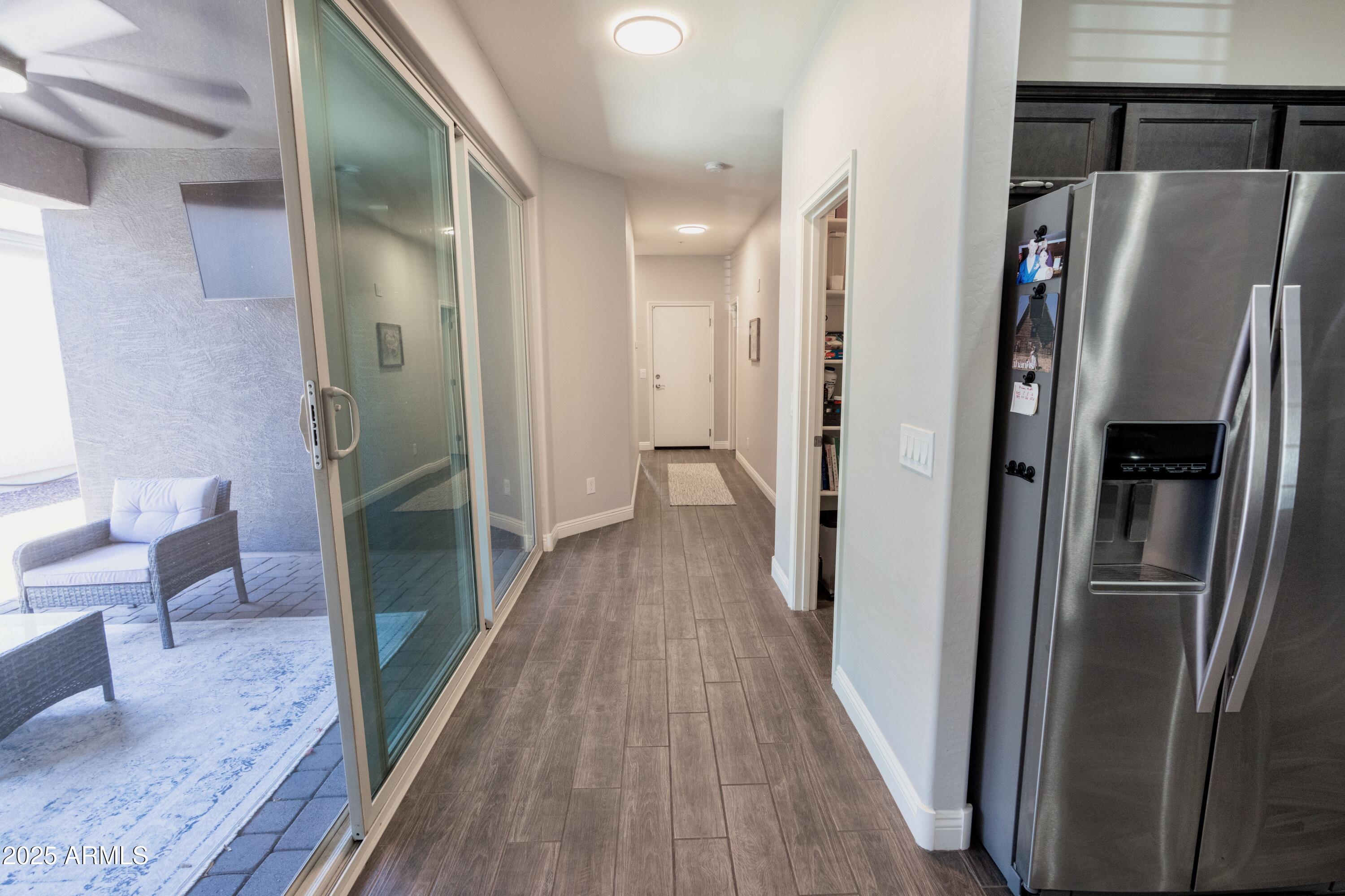 20753 West Legend Trail Buckeye, AZ 85396 - Photo 5 of 21 a view of a hallway with wooden floor and furniture