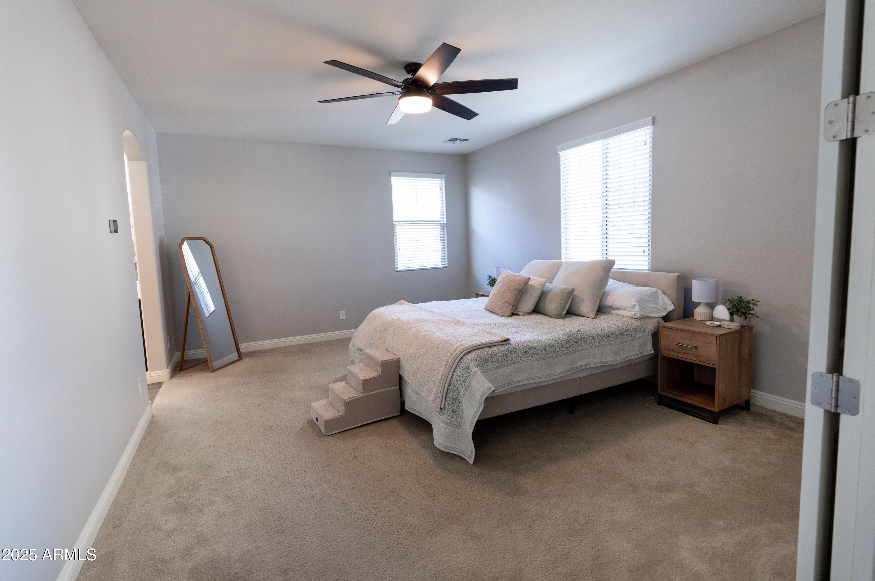 20753 West Legend Trail Buckeye, AZ 85396 - Photo 7 of 21 a bedroom with a bed chair and a window