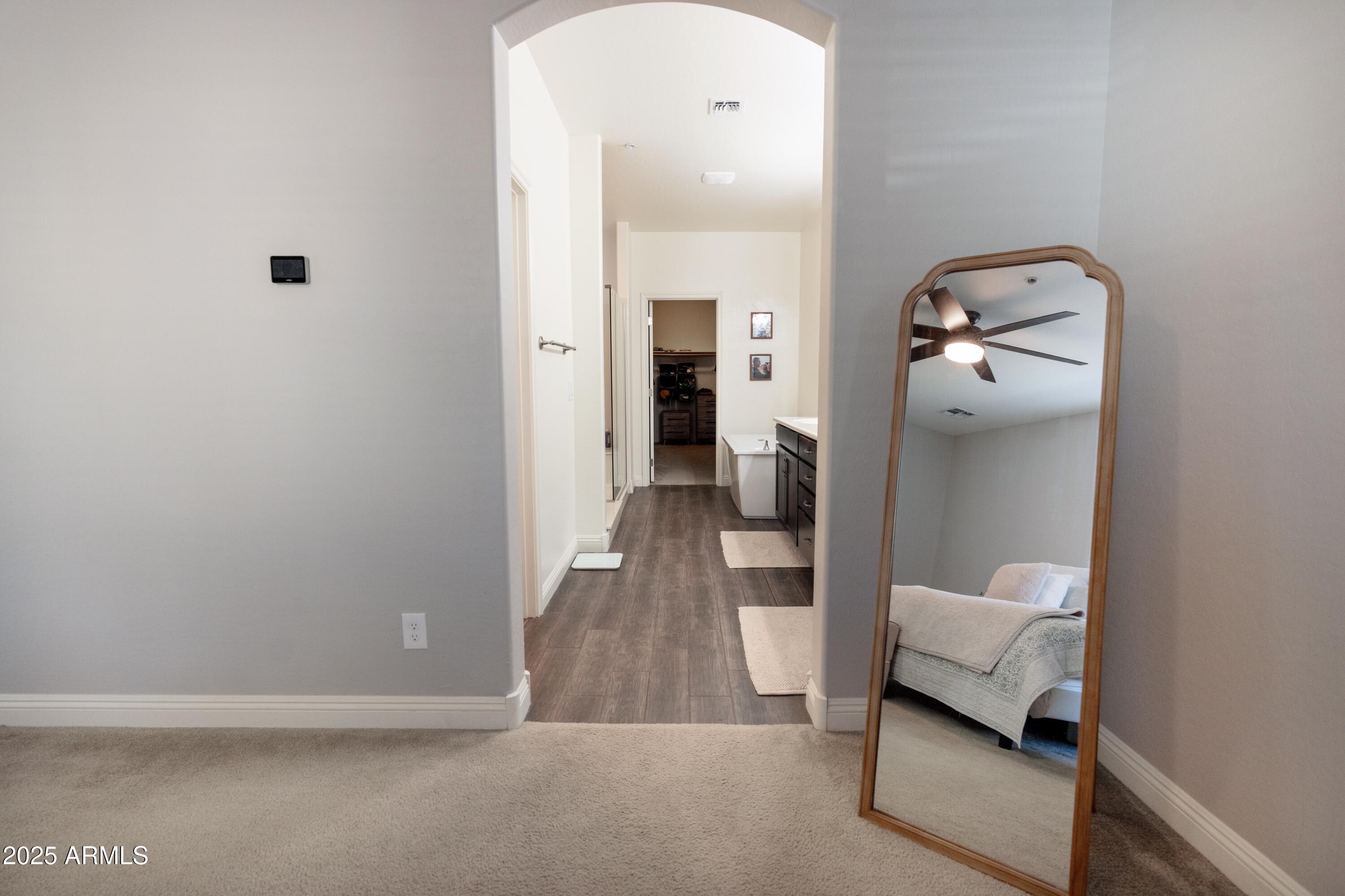 20753 West Legend Trail Buckeye, AZ 85396 - Photo 8 of 21 a view of a hallway with a room and a mirror