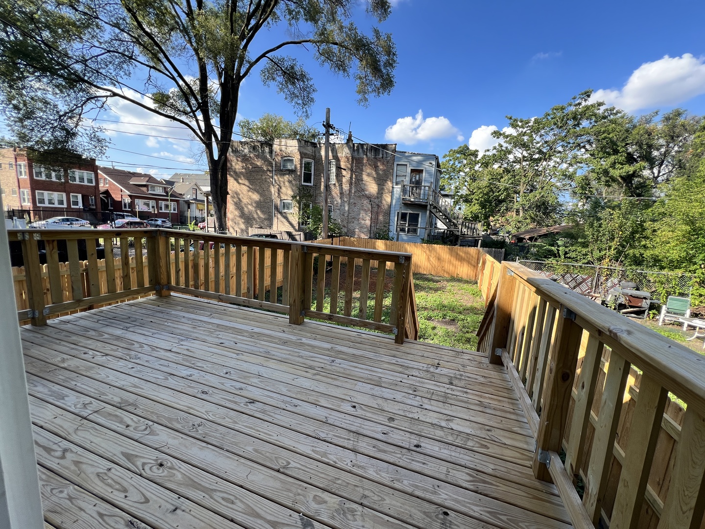 5320 West Ohio Street Chicago, IL 60644 - Photo 22 of 27 a view of a balcony with wooden floor and fence