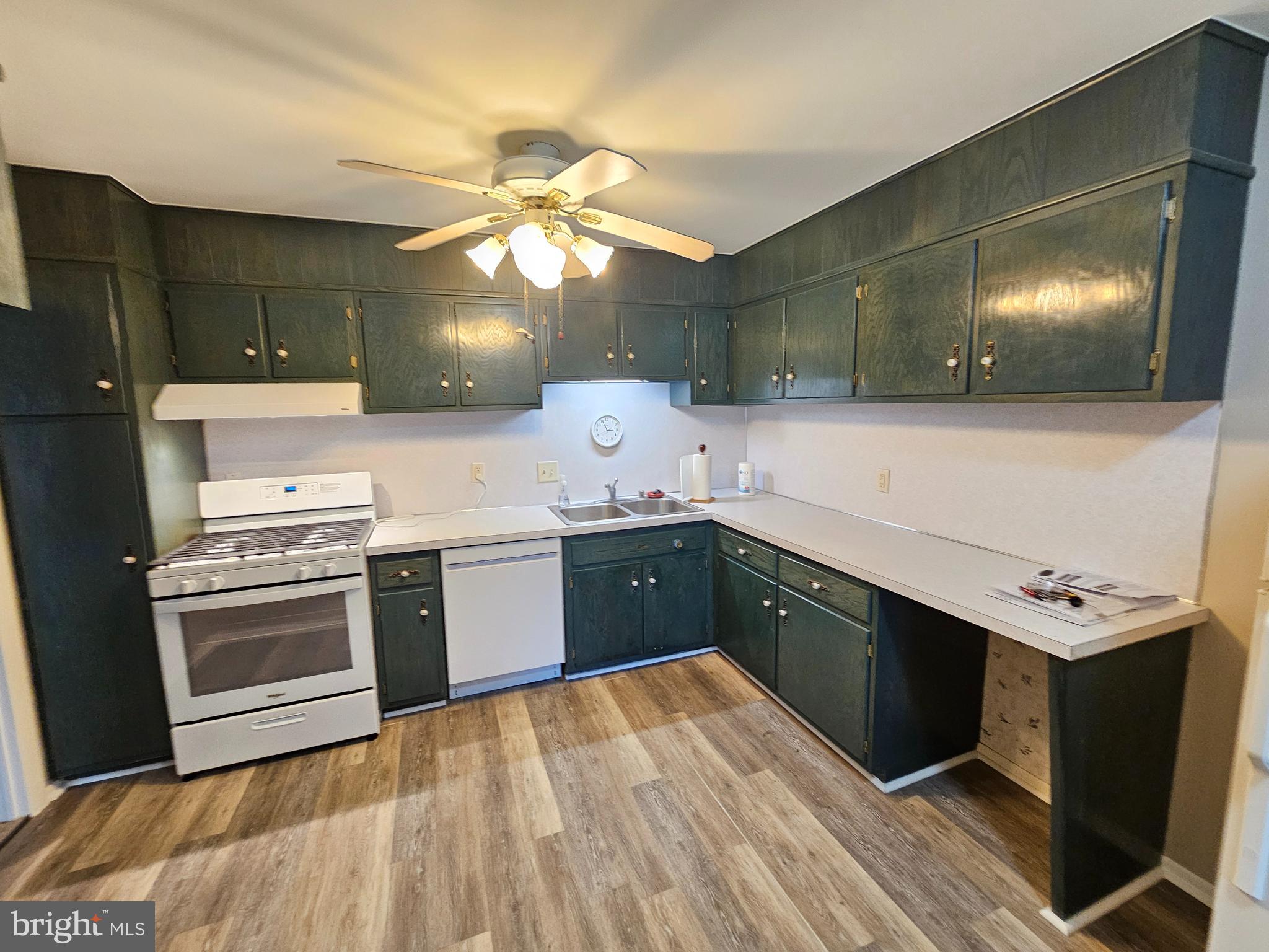 1375 Pershing Boulevard, Unit 307 Reading, PA 19607 - Photo 7 of 19 a kitchen with a stove cabinets and wooden floor