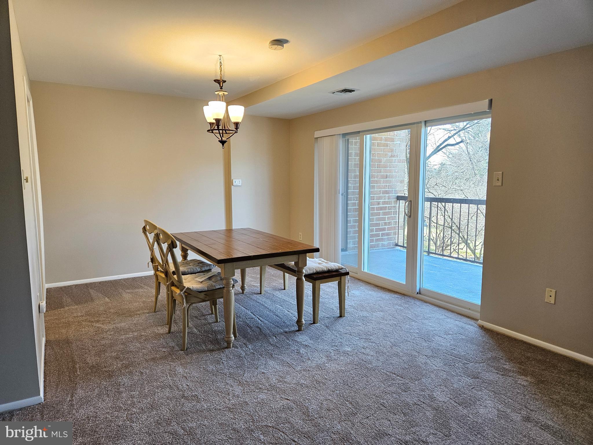 1375 Pershing Boulevard, Unit 307 Reading, PA 19607 - Photo 10 of 19 a view of a dining room with furniture wooden floor and chandelier