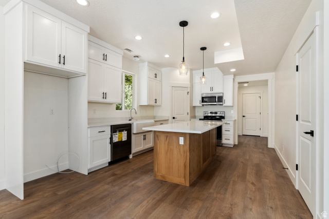504 North 650 E Street Springville, UT 84663 - Photo 5 of 36 Modern kitchen featuring a wood-finish island with a light-toned countertop