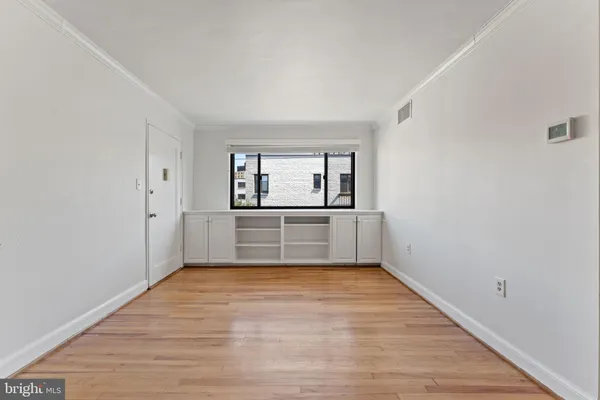 a view of a room with window and wooden floor
