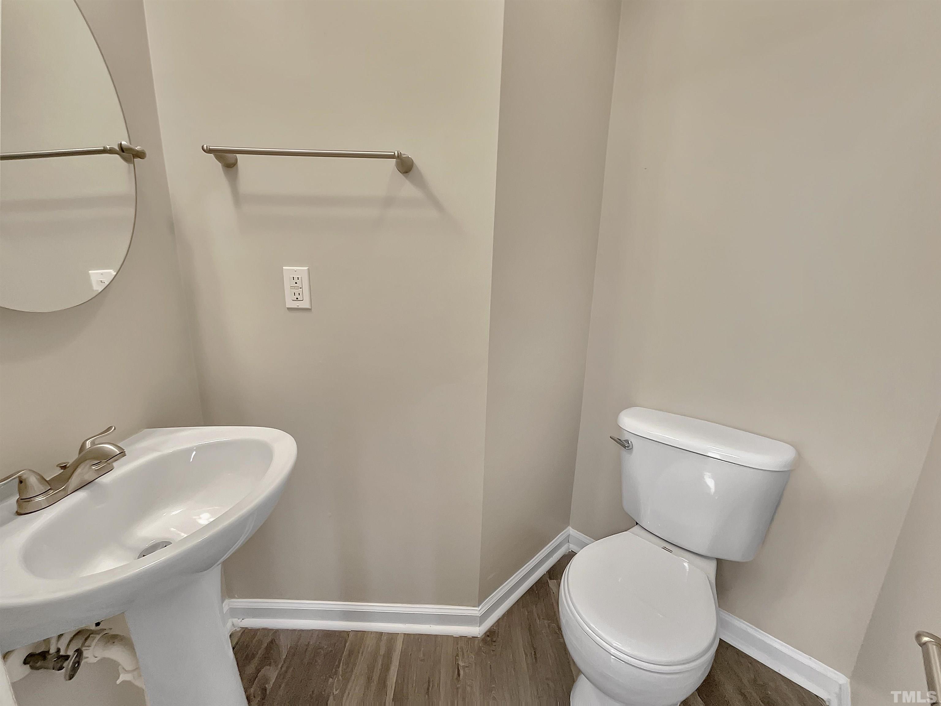 3360 Marshlane Way Raleigh, NC 27610 - Photo 11 of 17 a white toilet sitting next to a bathroom sink