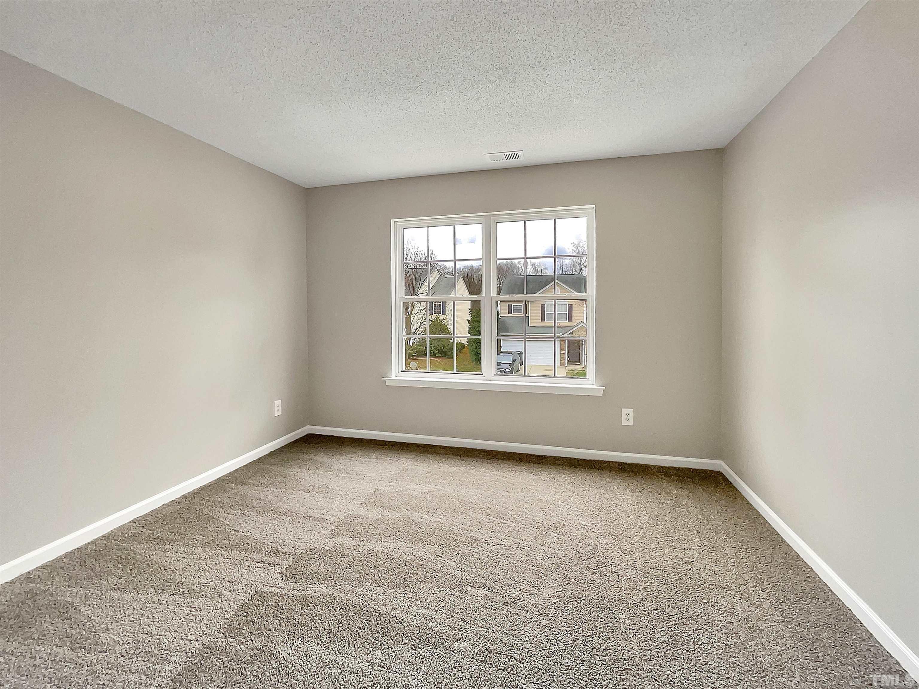 3360 Marshlane Way Raleigh, NC 27610 - Photo 14 of 17 an empty room with windows