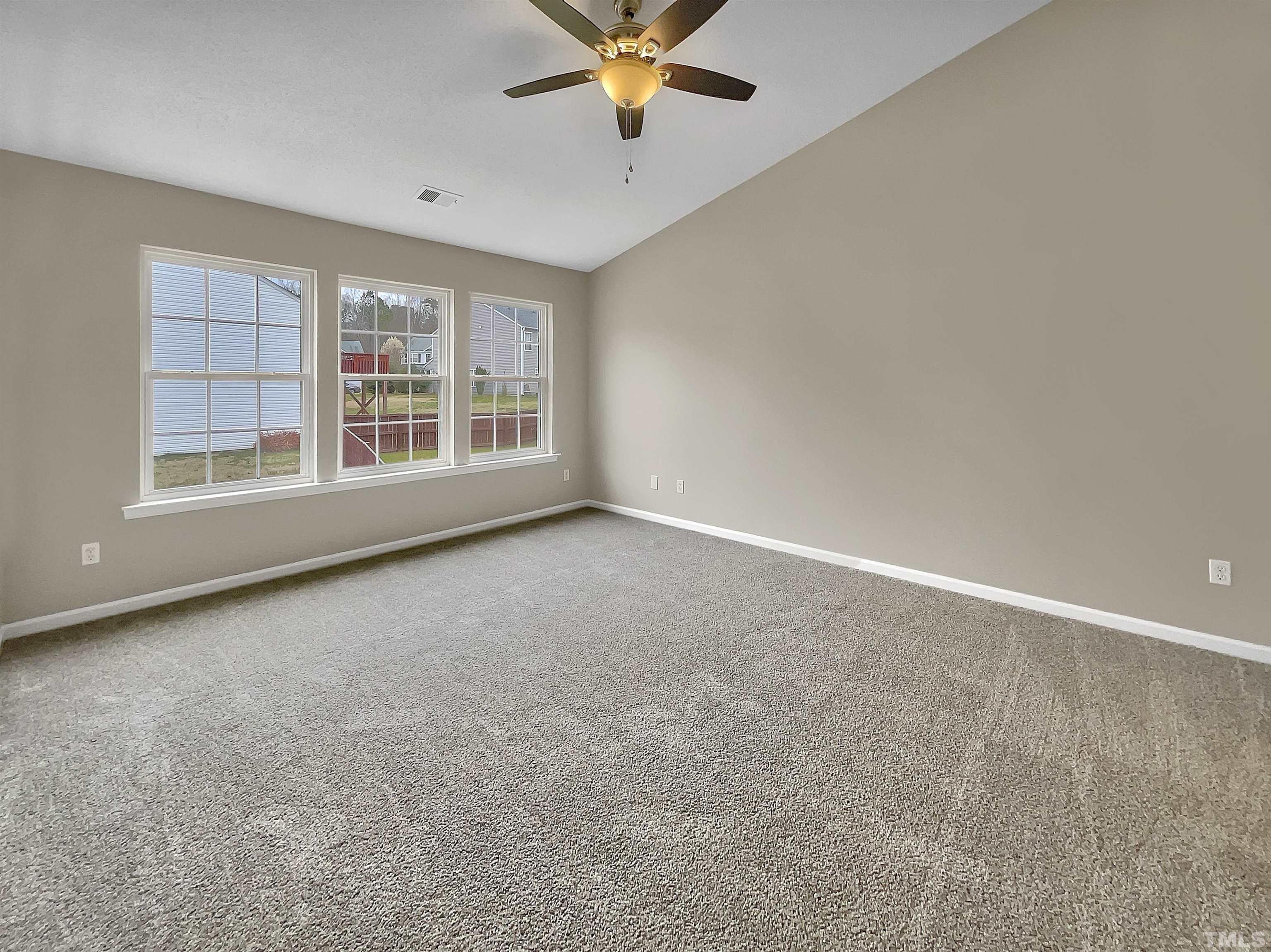 3360 Marshlane Way Raleigh, NC 27610 - Photo 15 of 17 an empty room with windows and ceiling fan