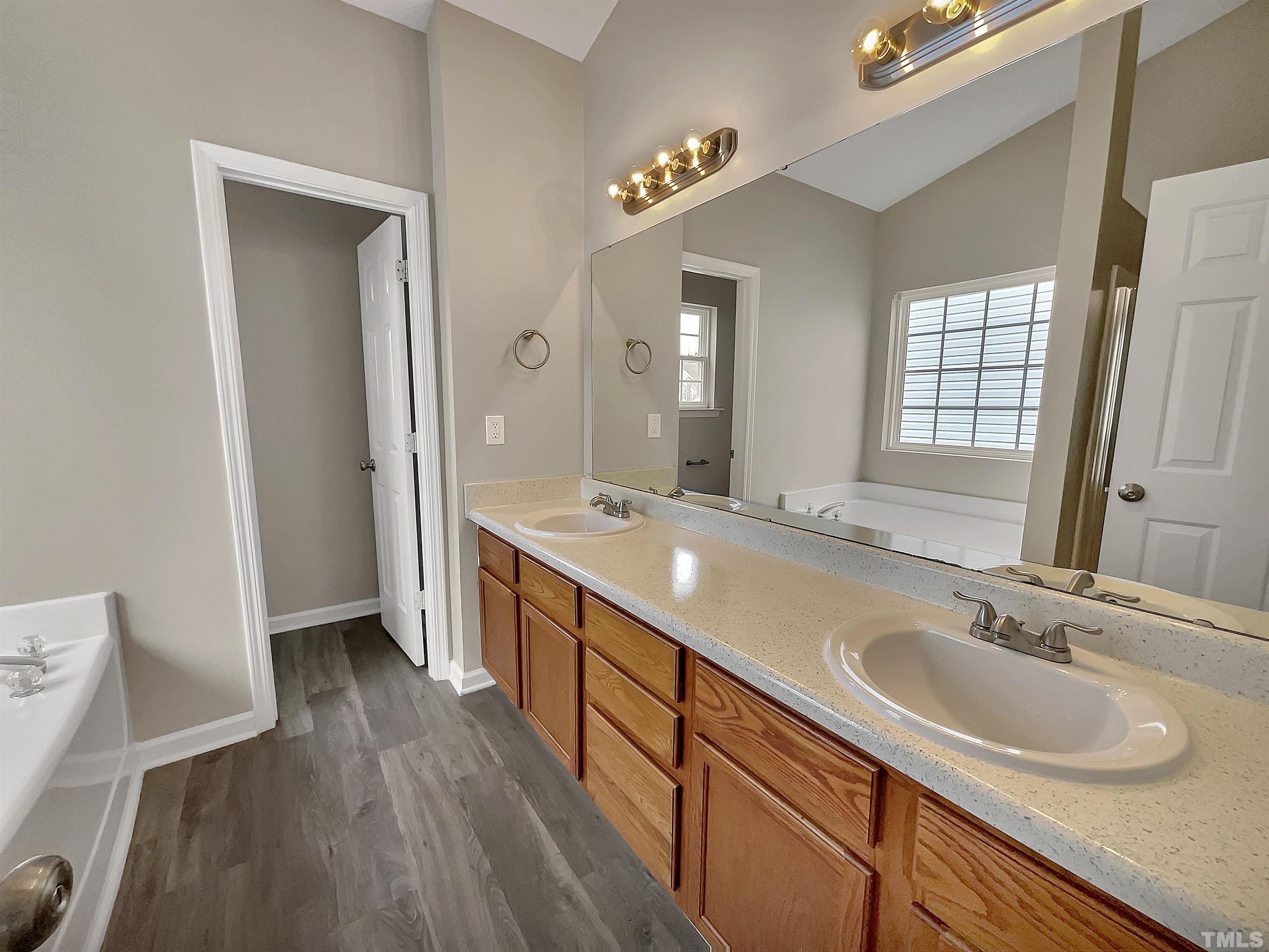 3360 Marshlane Way Raleigh, NC 27610 - Photo 4 of 17 a bathroom with double vanity sink and a mirror