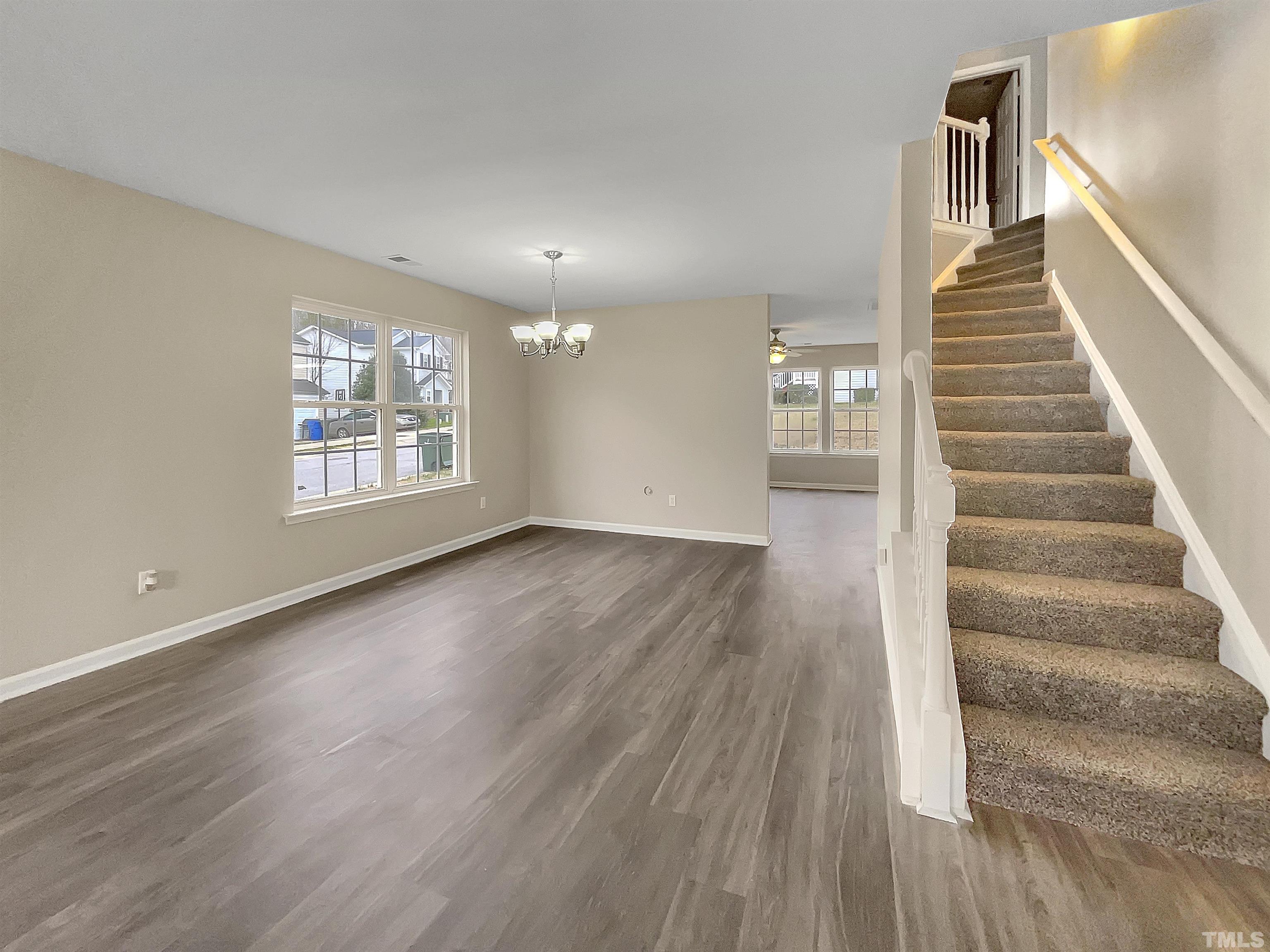 3360 Marshlane Way Raleigh, NC 27610 - Photo 6 of 17 wooden floor in an empty room with a window