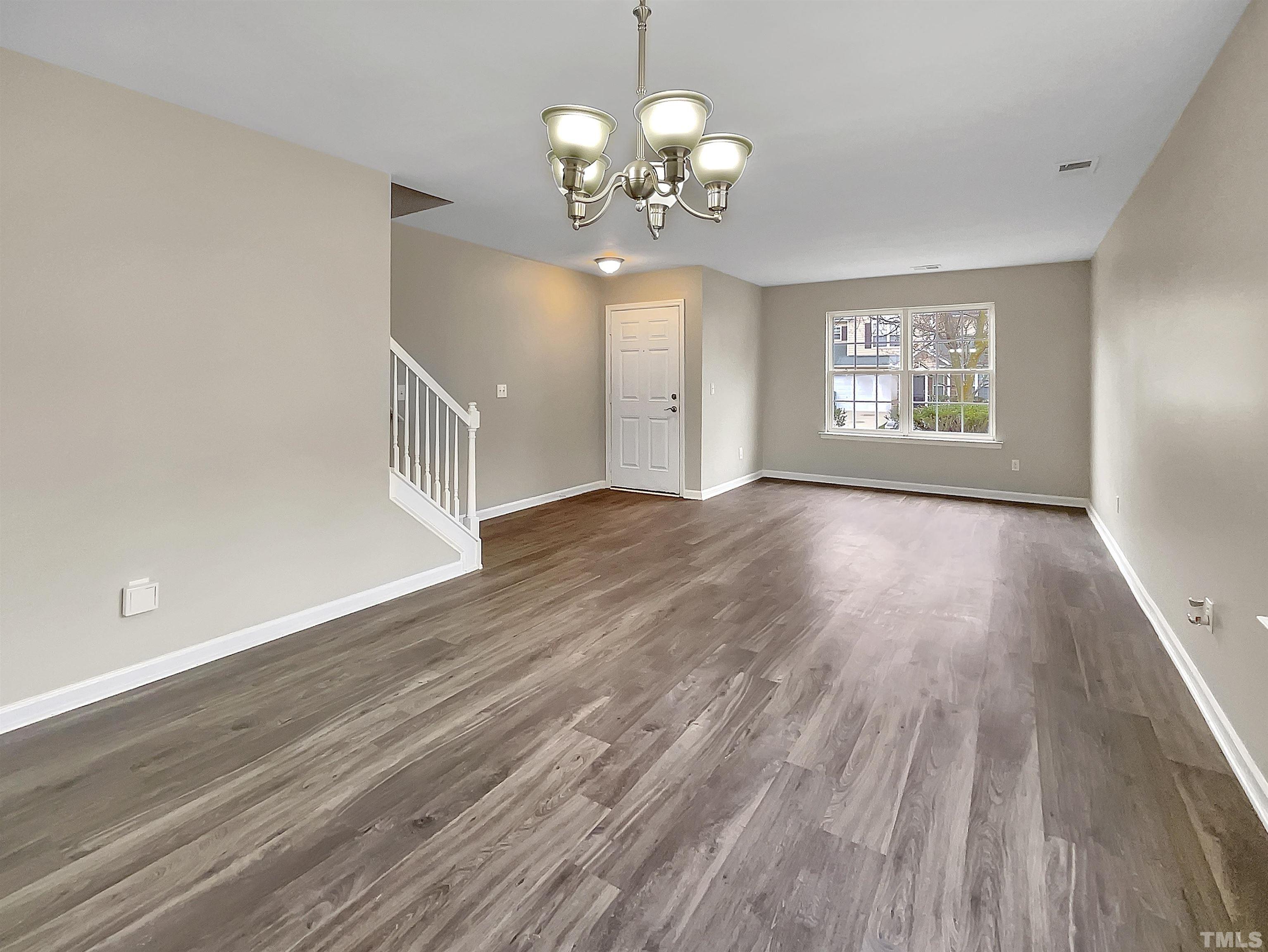 3360 Marshlane Way Raleigh, NC 27610 - Photo 7 of 17 a view of an empty room with wooden floor and a window