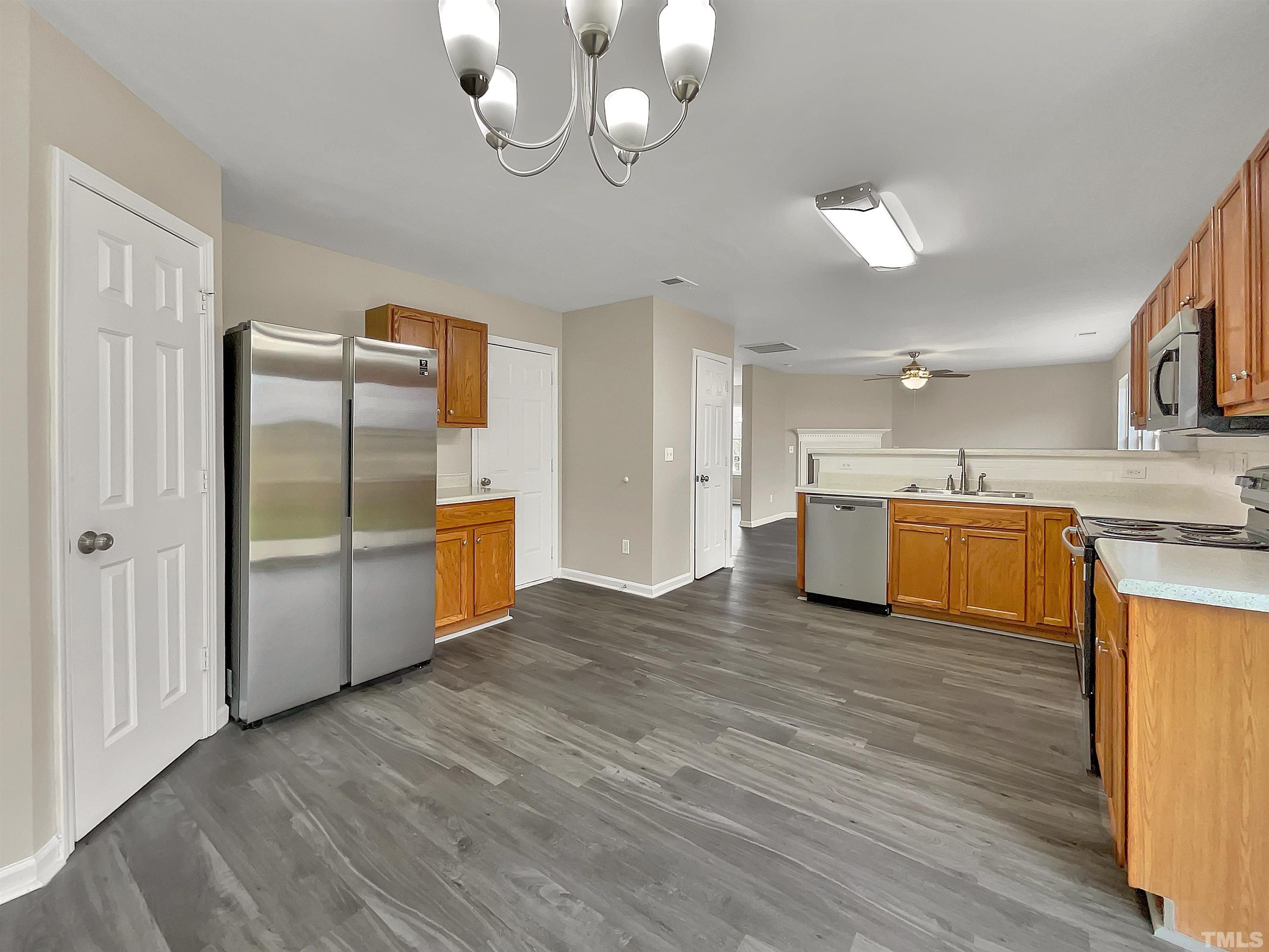 3360 Marshlane Way Raleigh, NC 27610 - Photo 9 of 17 a kitchen with stainless steel appliances a refrigerator and a sink