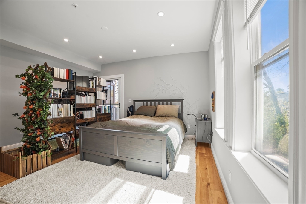 58 Weld Hill Street, Unit 2 Boston, MA 02130 - Photo 13 of 17 a bed room with a bed and a book shelf