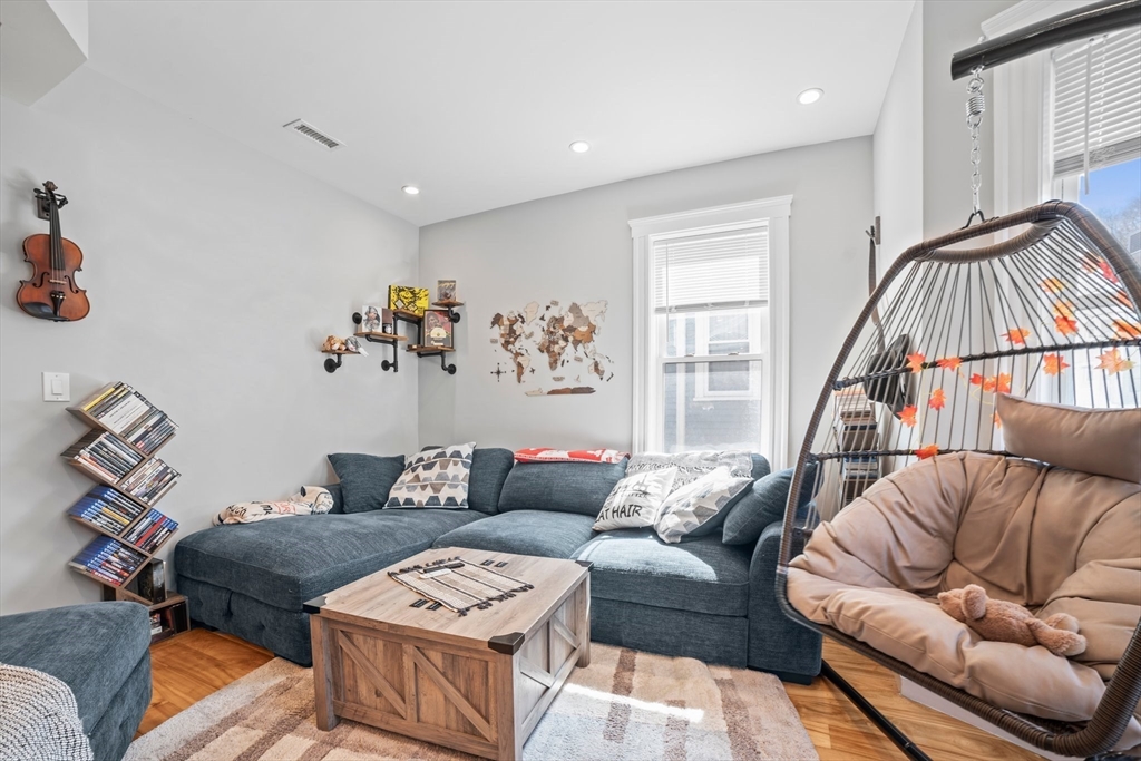 58 Weld Hill Street, Unit 2 Boston, MA 02130 - Photo 2 of 17 a living room with furniture and a window