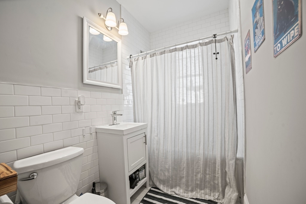 58 Weld Hill Street, Unit 2 Boston, MA 02130 - Photo 7 of 17 a bathroom with a sink a toilet and shower