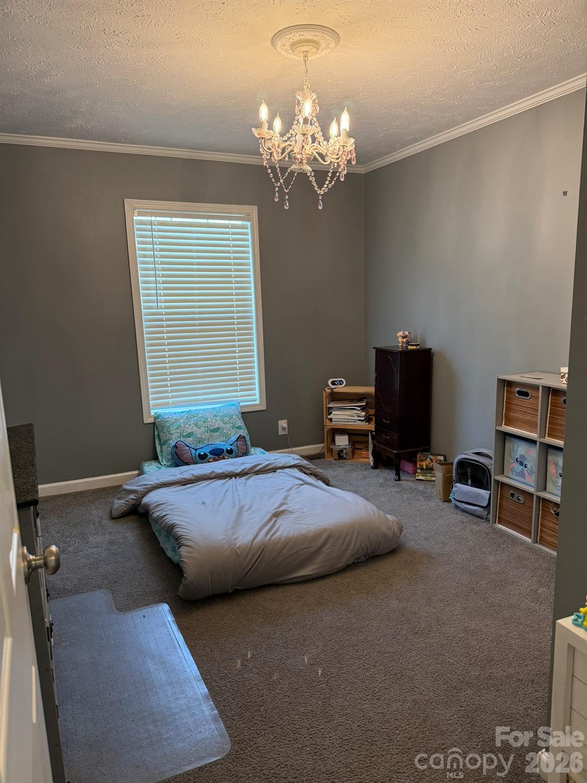 288 Walker Road Nebo, NC 28761 - Photo 14 of 18 a bedroom with a bed and a chandelier