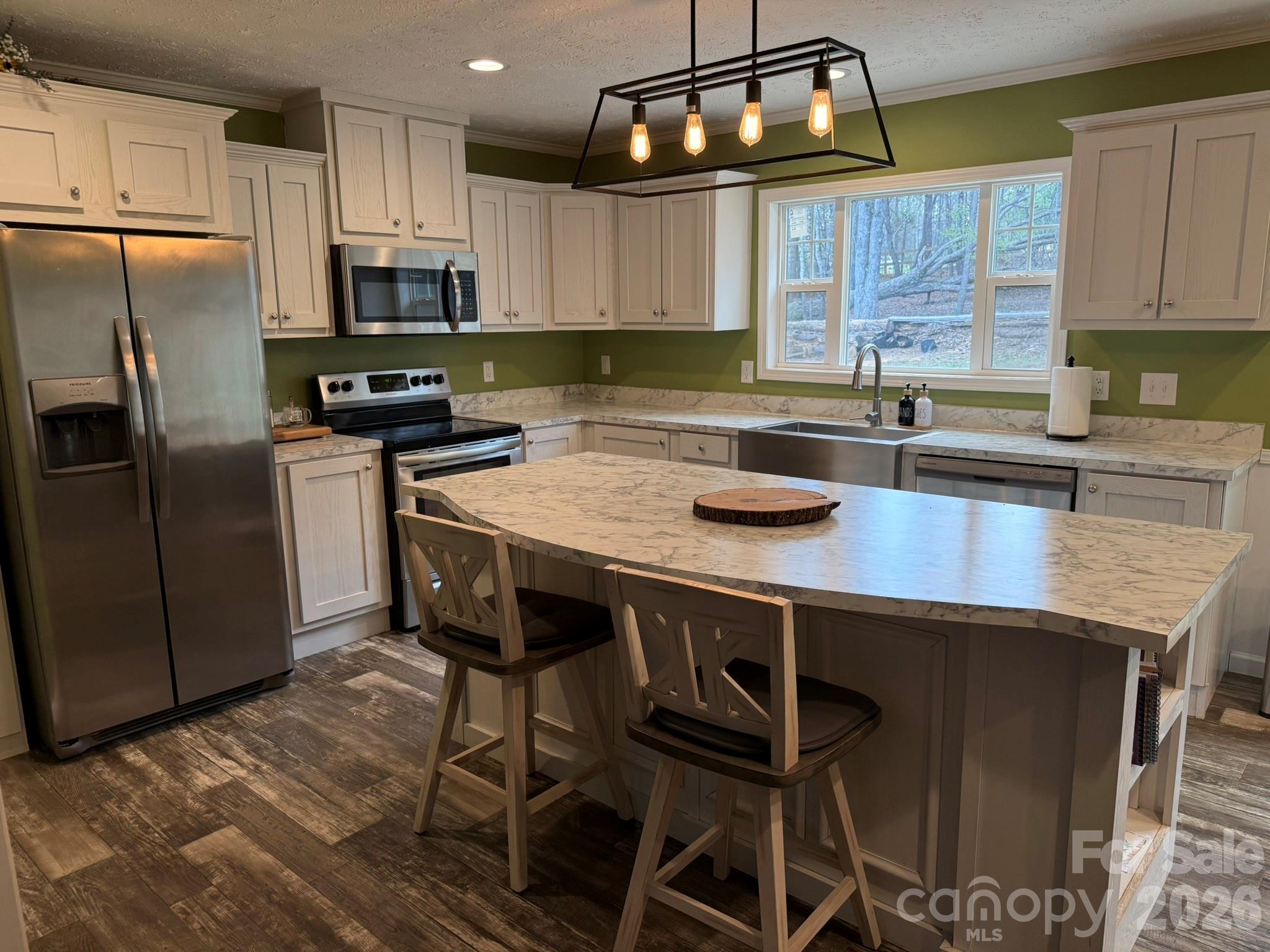 288 Walker Road Nebo, NC 28761 - Photo 5 of 18 a kitchen with stainless steel appliances granite countertop a sink a stove a table and chairs