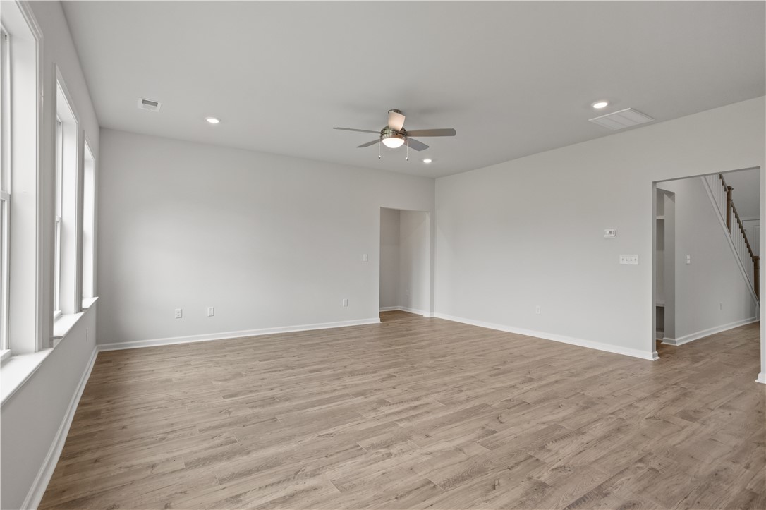 555 Hydrangea Street, Unit LOT 47 Seneca, SC 29678 - Photo 15 of 38 A spacious, naturally illuminated room features light wood flooring and a refreshing ceiling fan.