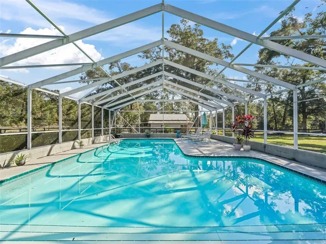 a view of a swimming pool with a patio