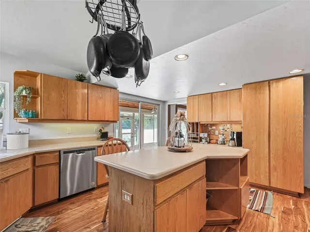 a kitchen with a sink a stove and cabinets