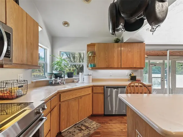 a kitchen with a sink a stove and cabinets