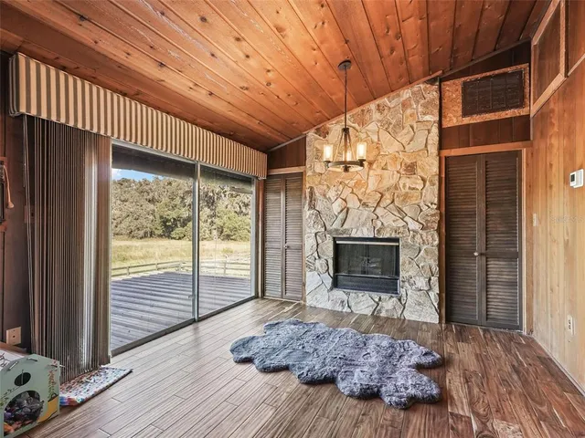 a living room with a couch wooden floor and a fireplace