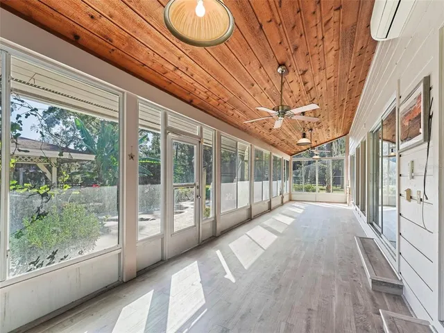 a view of a porch with wooden floor and fence