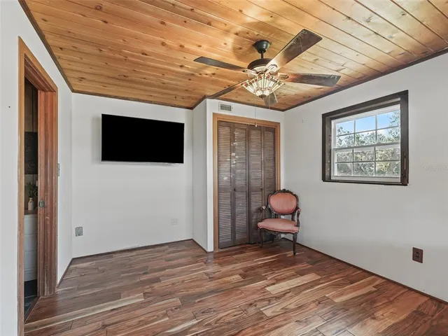 a view of a livingroom with furniture and chandelier fan