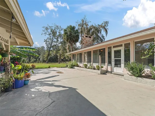 a view of a house with backyard and sitting area