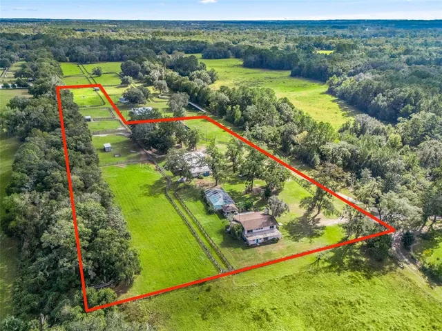an aerial view of a houses with swimming pool